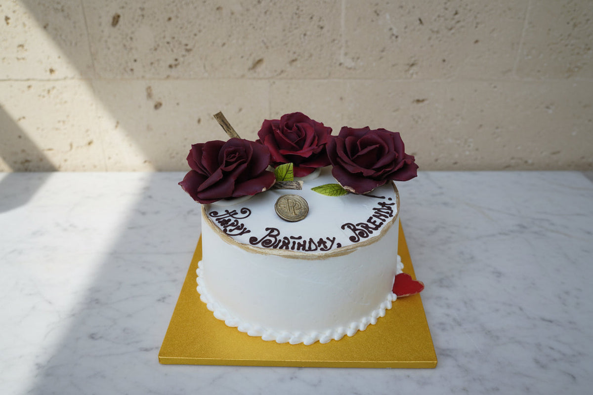 Prestige Patisserie whole cake with red chocolate roses design and chocolate message