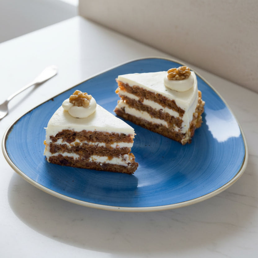 Carrot and walnut cake slice with cream cheese frosting from Prestige Patisserie North London
