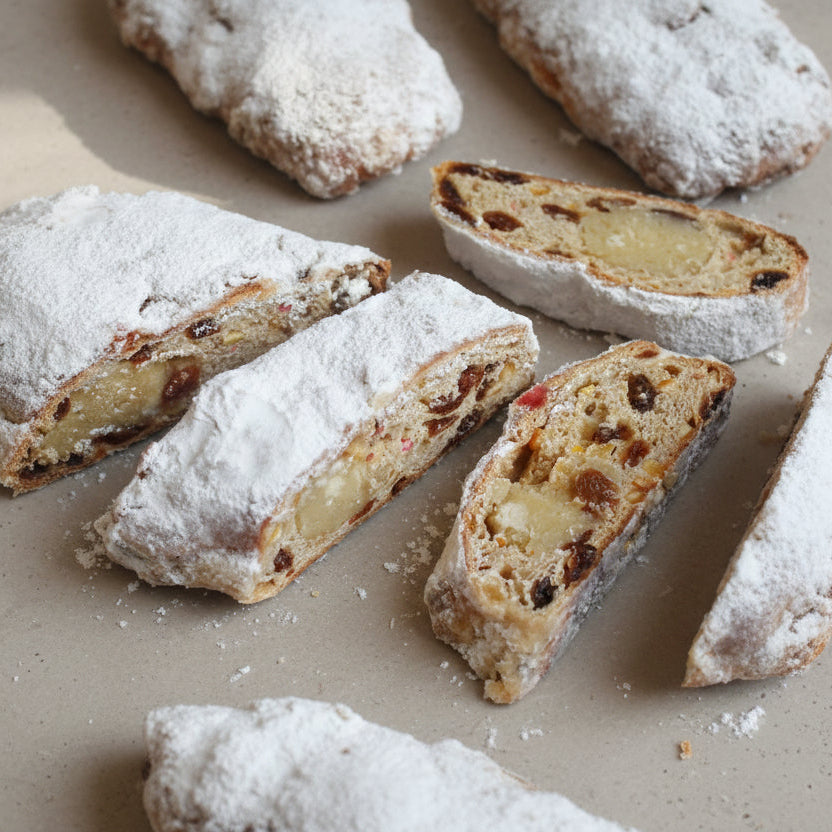 Handmade Christmas stollen with marzipan, cherries, and icing sugar from Prestige Patisserie.