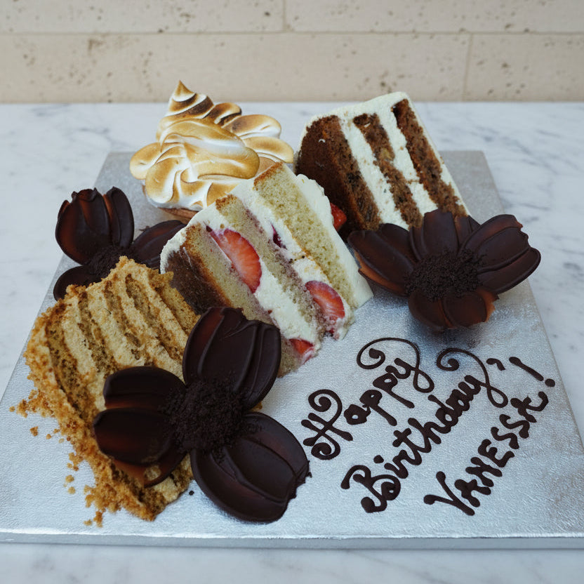 Birthday card with cake design and 'Happy Birthday Vanessa!' text on a wooden surface.