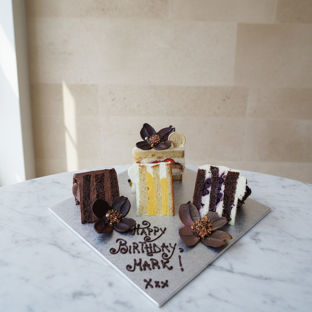 Small birthday cake with flowers on a wooden surface