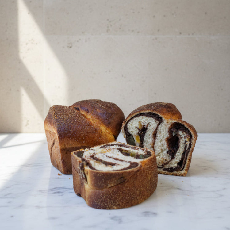 Traditional Romanian Cozonac sweet bread with chocolate, walnut, and orange zest swirl baked at Prestige Patisserie in North London