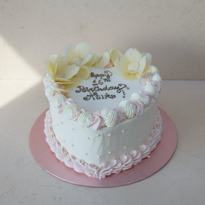 Luxury vintage heart birthday cake with pastel buttercream piping and personalised chocolate message in North London bakery
