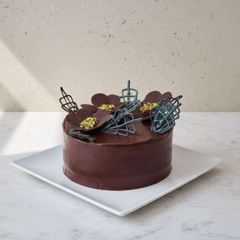 Close-up of a rich, layered chocolate cake with mousse and ganache finish made on our masterclass in London