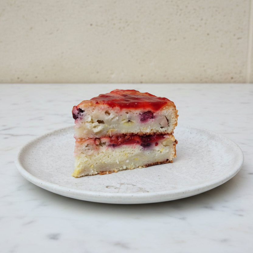 vegan banana berries coconut cake slice with fresh berries