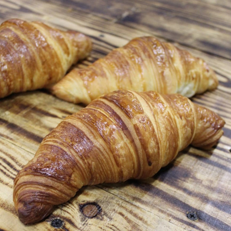 Golden butter croissants in a set of four, hand-laminated and baked fresh in North London using 100% butter and fresh milk