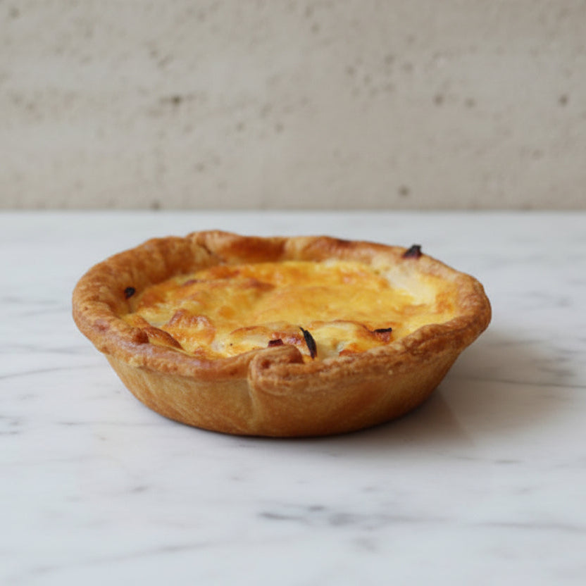 Flaky chicken and smoked pancetta quiches with golden pastry and creamy custard filling, handmade in North London bakery, served in sets of four