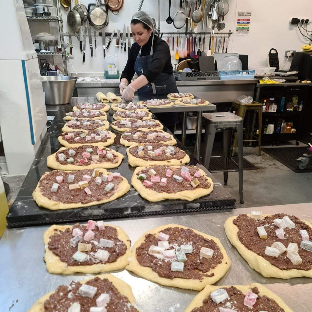 Traditional Romanian Cozonac sweet bread with a cocoa, orange zest and Turkish Delight filling, sliced to reveal its marbled interior