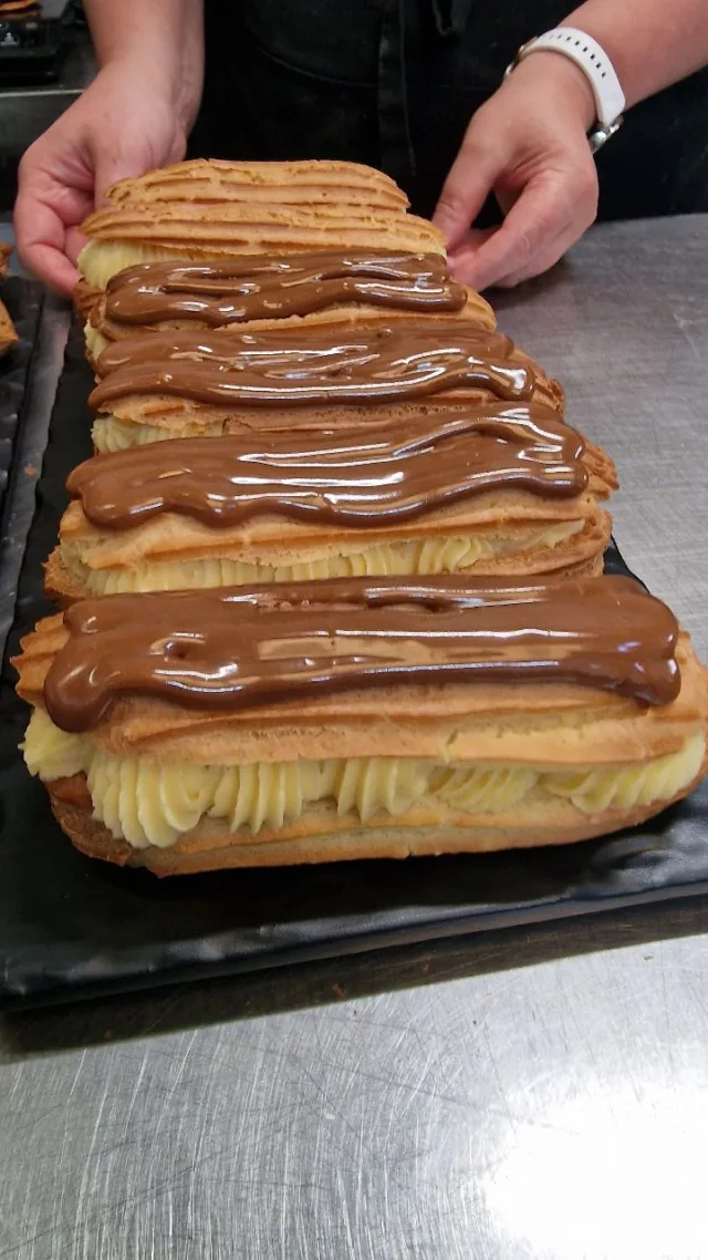 Freshly filled. Freshly made.  Watching Geanina fill our handcrafted éclairs never gets old. Crisp choux pastry, silky crème pâtissière, and a rich chocolate & coffee fondant... simple ingredients, made with care.  Fancy one today?  You can:
📍 Visit us in our Tottenham bakery
🛵 Order on Uber Eats or Deliveroo
🍰 Treat yourself without leaving home!  #PrestigePatisserie #Eclairs #FrenchPastry #FreshlyMade #LondonBakery